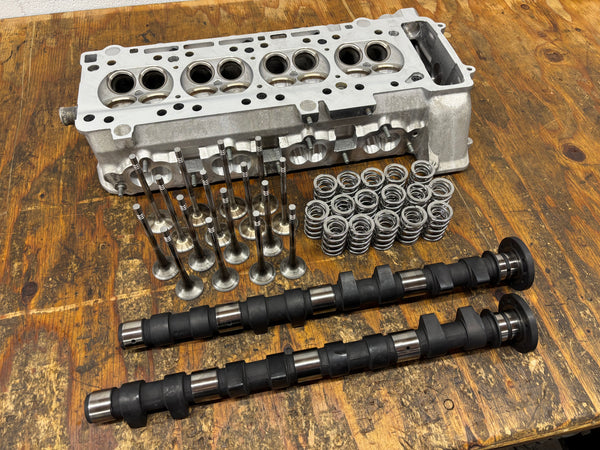BimmerHeads BMW S14 M3 cylinder head with Supertech valve springs and other parts.