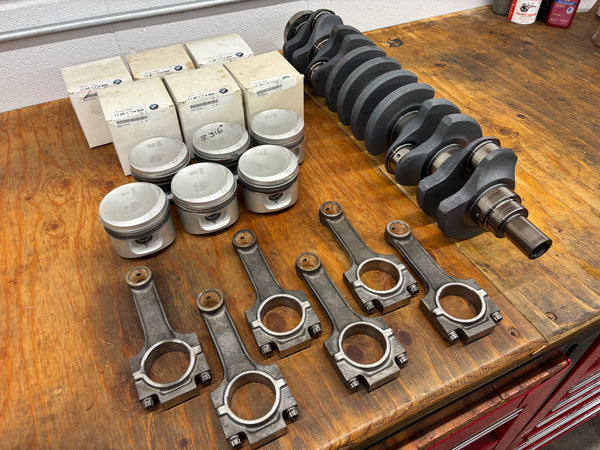 New OE BMW Super Eta pistons for BimmerHeads Super Sport engine build. Shown with crankshaft and rods.