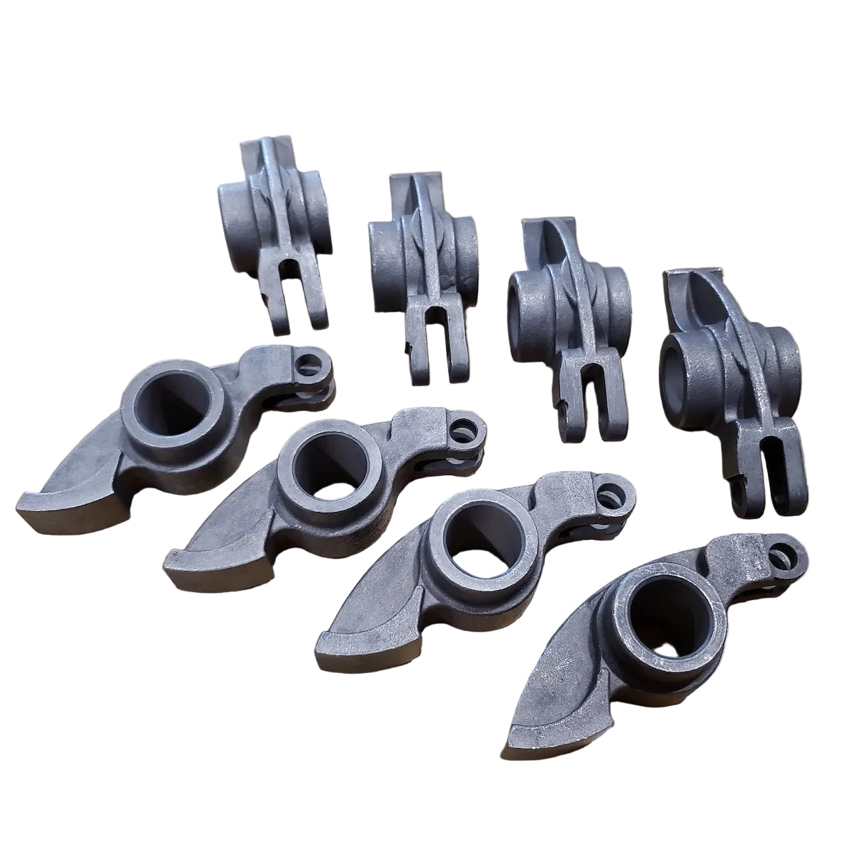 A set of eight gray forged steel rocker arms for a BMW M10 engine.