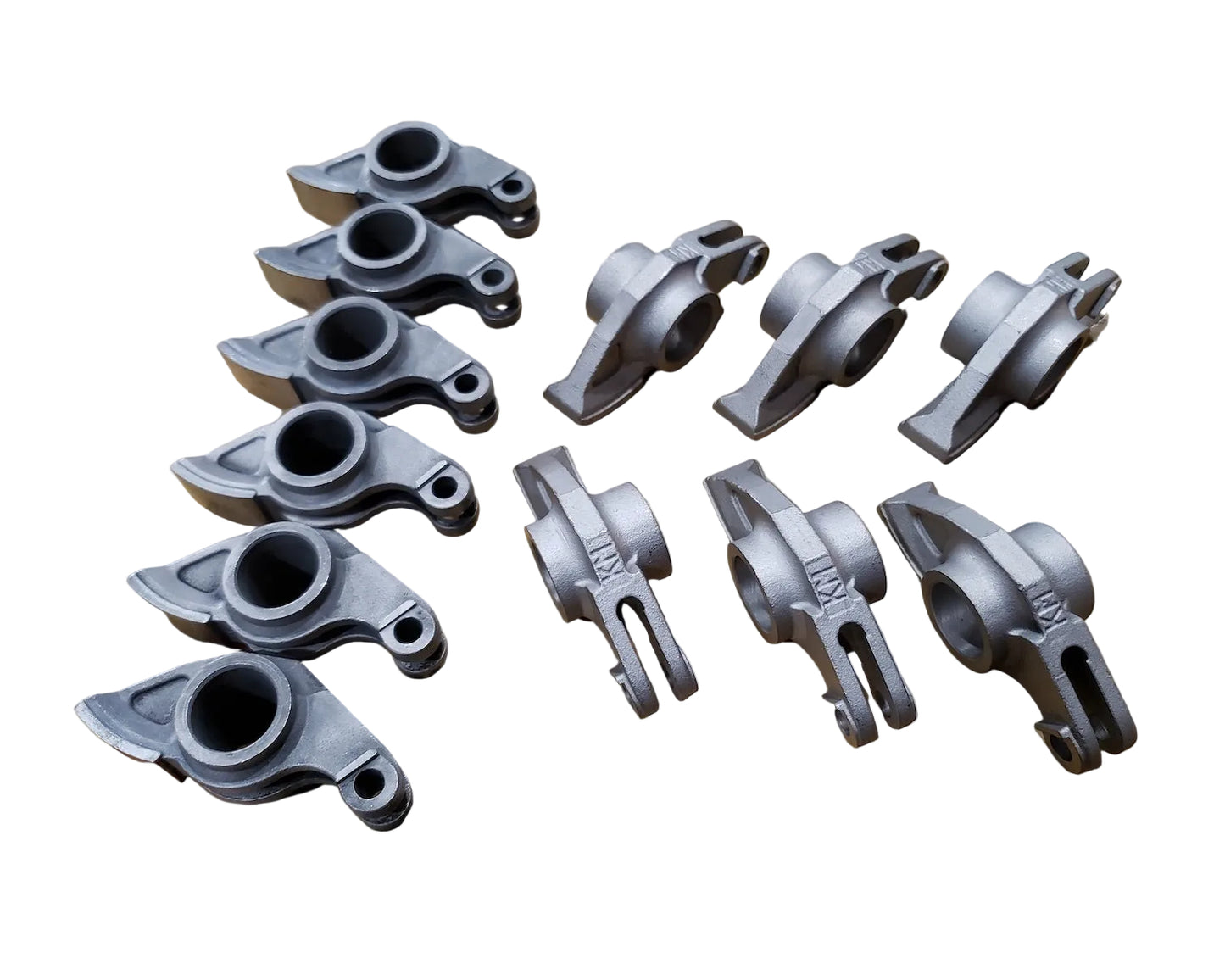 A set of 12 forged steel racing rocker arms for BMW M20 engine. Made by KM Cams.