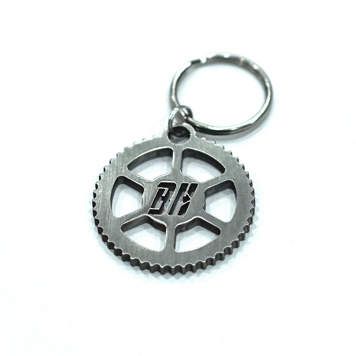 A stainless steel key tag with a gear design and the letters 'BH' in the center, attached to a keyring.