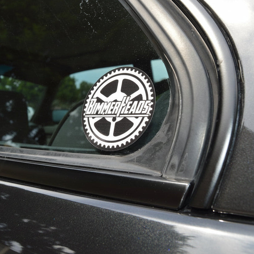 Round BimmerHeads sticker shown on BMW E30 rear side window.