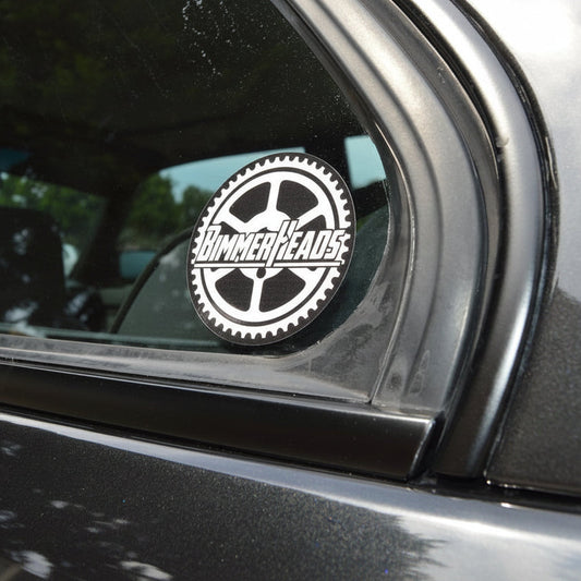 Round BimmerHeads sticker shown on BMW E30 rear side window.