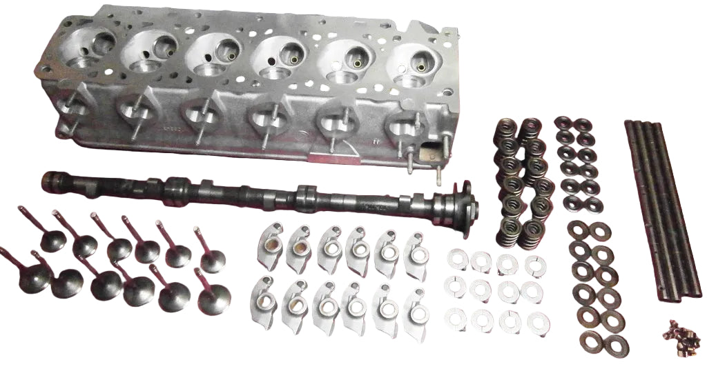 BimmerHeads BMW M30 performance cylinder head and parts laid out on table.
