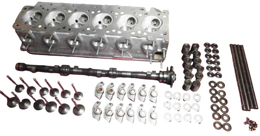 BimmerHeads BMW M30 performance cylinder head and parts laid out on table.